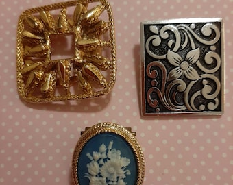 3 x Vintage Scarf Clips 1 x Goldtone, 1 x Silvertone Floral, 1 x Blue Floral Cameo, Good condition.