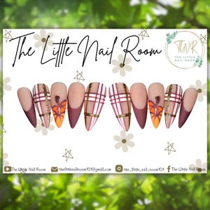 May include: A set of false nails with a seasonal autumn theme. The nails display a plaid pattern in burgundy and white, with gold glitter detailing. One nail features an orange pumpkin design. The text "The Little Nail Room" is at the top.