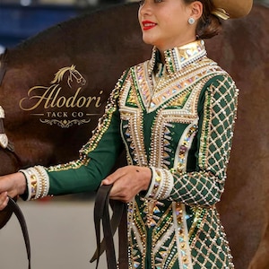 May include: A green and gold equestrian show jacket with intricate beading and embellishments. The jacket features a high collar and long sleeves, paired with a tan cowboy hat. The "Alodori Tack Co" logo is visible.