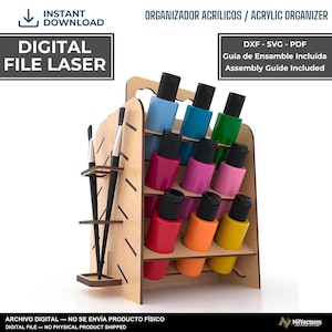 Puede incluir: Un organizador de madera clara con asa, que presenta tres niveles de aberturas circulares para doce botes de pintura de colores con tapas negras, y un soporte lateral para dos pinceles. El texto incluye DIGITAL FILE LASER.
