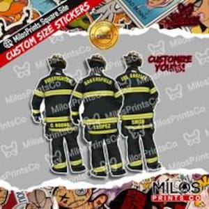 May include: Three firefighter figures seen from the back, wearing dark navy turnout gear with yellow reflective stripes. The jackets feature text including FIREFIGHTER, BAKERSFIELD, LOS ANGELES, C. BOONALL, LOPEZ, and SMITH. Text reads CUSTOMIZE YOURS.