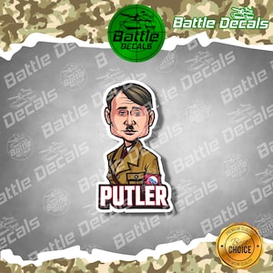 May include: A cartoon sticker featuring a caricature of a man in a military-style uniform. The sticker has the word "PUTLER" in bold letters at the bottom. The background is a camouflage pattern with the words "Battle Decals" repeated.