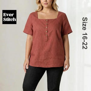 May include: A rust-coloured short-sleeve blouse featuring a square neckline and a vertical row of five buttons down the centre front. The garment is labelled Ever Stitch and indicates a size range of 16-22. It is paired with black trousers.