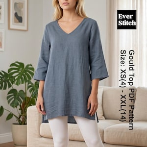 May include: A slate blue V-neck tunic top with three-quarter length sleeves and side slits. The image includes text that reads Ever Stitch Gould Top PDF Pattern Size: XS(4) - XXL(14). The top is paired with white cropped leggings.