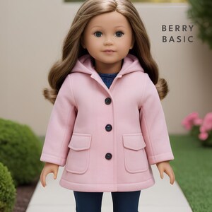 May include: A pink hooded coat with a button closure and two front pockets. The coat is made for a doll and has the text "BERRY BASIC" on the right side of the image.