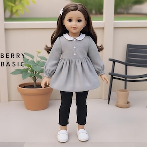 May include: A grey collared dress with a white collar and long sleeves. The dress has a gathered skirt and is worn with black leggings and white shoes. The doll is wearing a white headband with a bow.