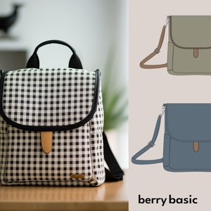 May include: A black and white gingham backpack with a black leather flap and a brown leather strap. The backpack is sitting on a wooden table. The image also shows two other bags in different colors, a green bag and a blue bag.