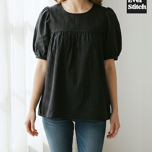 May include: Black short-sleeve top with a round neckline and embroidered detailing. The top has a loose, flowing fit and puffed sleeves. The brand name "Ever Stitch" is displayed in a black and white square.