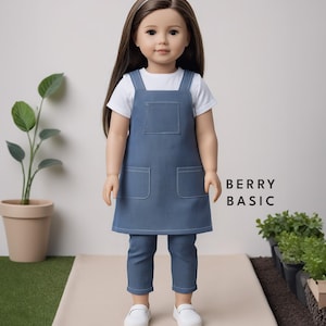 May include: A doll wearing a blue denim overall dress with white straps and two front pockets. The doll is also wearing a white t-shirt and blue denim pants. The doll has long brown hair and is wearing white shoes. The text "BERRY BASIC" is visible in the image.