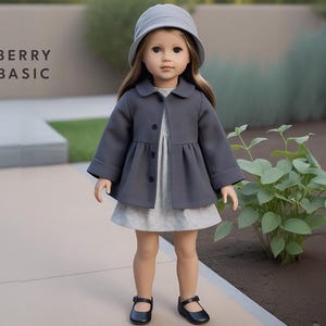 May include: A grey doll wearing a grey coat with a black button fastening, a grey dress, a grey hat, and black shoes. The doll is standing on a grey surface.