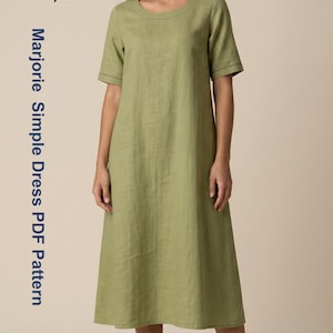 May include: A light green dress with short sleeves and a round neckline. The dress has a simple design and falls to the mid-calf. The text "berry basic" and "Marjorie Simple Dress PDF Pattern" are visible.