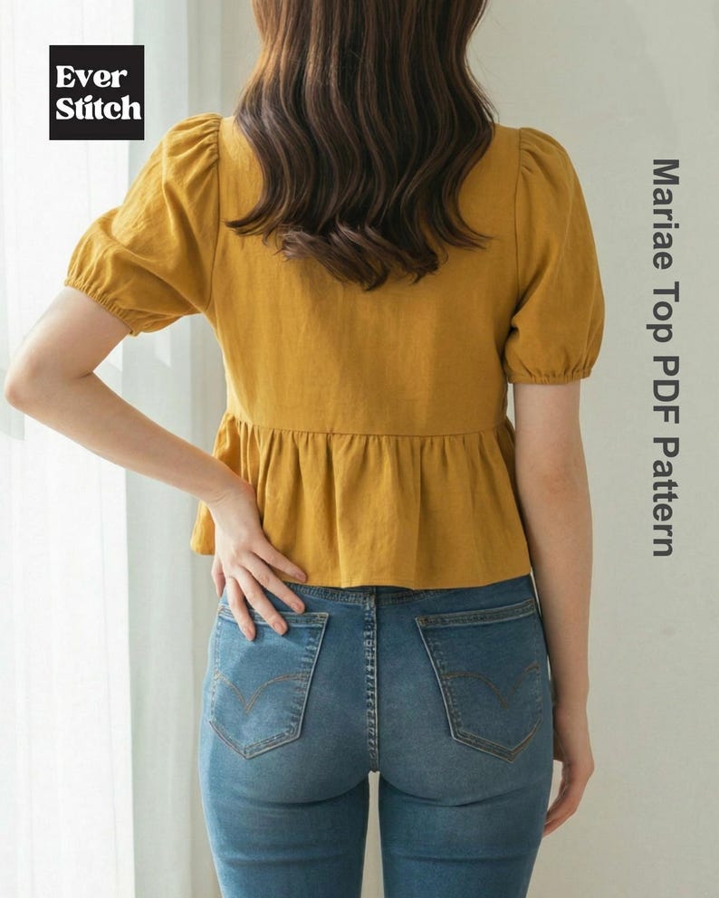 May include: Mustard yellow top with short, puffed sleeves and a peplum waist, paired with blue denim jeans. The image includes the text "Mariae Top PDF Pattern" and the "Ever Stitch" logo.