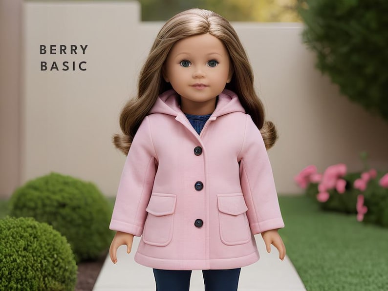 May include: A pink hooded jacket with a button closure and two pockets. The jacket is made for a doll and has the text "BERRY BASIC" on the background.