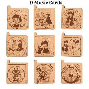 May include: Nine wooden music cards featuring characters from the animated film 'Kiki's Delivery Service'. Each card has a different illustration and is decorated with stars, hearts, and musical notes.