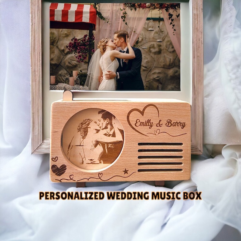 May include: Personalized wooden music box with a photo of a couple kissing and the text "Emilly & Barry" engraved on the front. The music box is shaped like a vintage radio.