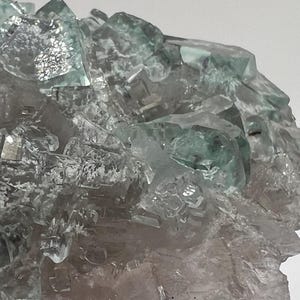 Clear aqua colored fluorite with inclusions and calcite from Xianghualing, China. Rocks Minerals Crystals