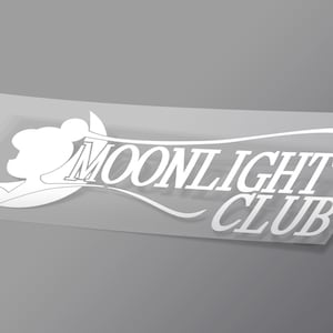 May include: White sticker with the text "MOONLIGHT CLUB" in a stylized font. The design includes a crescent moon and a cloud-like shape. The sticker is on a transparent backing, set against a gray background.