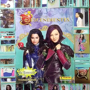 May include: A sticker album cover featuring the Disney Descendants characters Mal and Evie. The cover is purple and teal with a large apple and the text "Disney Descendants" and "Be Yourself Sticker Album".