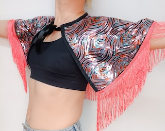 Peacock feather pattern sequinned cape with pink fringing and black ribbon fastening