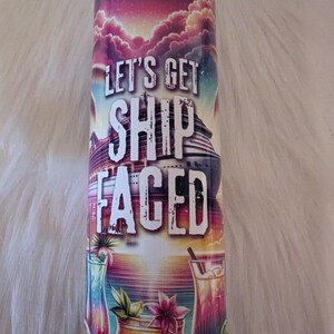 May include: A colourful stainless steel tumbler with a sunset and cruise ship graphic. The text "Let's Get Ship Faced" is printed on the tumbler.