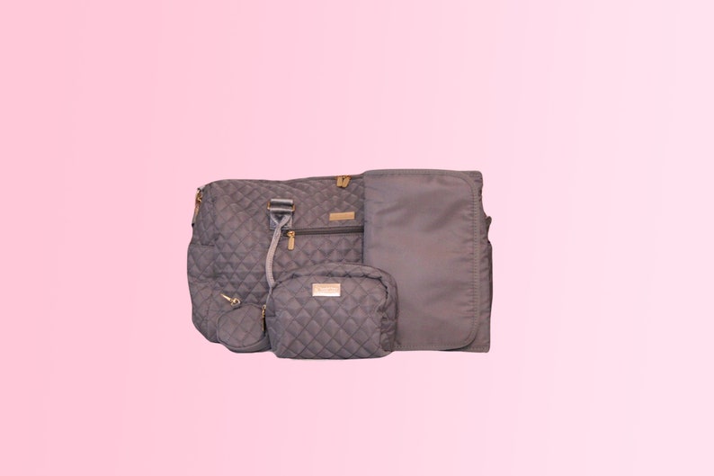 May include: A set of four gray quilted bags with gold accents. The set includes a large tote bag, a smaller crossbody bag, a cosmetic bag, and a small round pouch.
