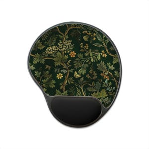 May include: Ergonomic mouse pad with a dark green floral pattern featuring leaves, flowers, and a butterfly. The pad has a black wrist rest for comfort and a curved shape. The design is reminiscent of a botanical illustration.