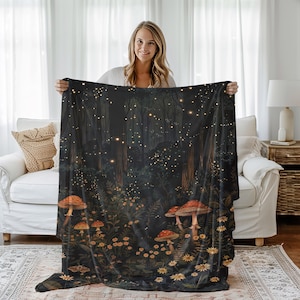 May include: A black fleece throw blanket with a dark forest scene featuring glowing fireflies, mushrooms, and flowers.