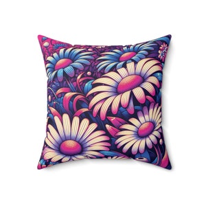 May include: A decorative pillow featuring a vibrant floral pattern with pink, blue, and white daisies on a dark blue background.