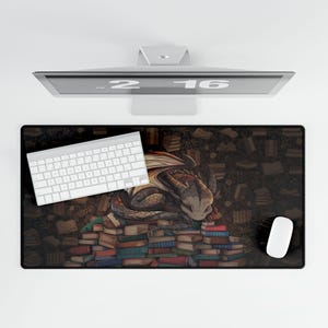 May include: A black and brown mousepad with a dragon sleeping on a pile of books. The dragon is green and brown with a light brown underbelly. The books are stacked in a pile and are various colors. The mousepad is surrounded by a dark brown background with a pattern of small books.