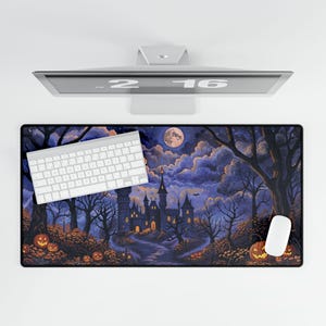 May include: A rectangular Halloween-themed desk mat featuring a spooky castle scene under a full moon. The design includes jack-o'-lanterns, trees, and a winding path. A white keyboard and mouse are on the mat.