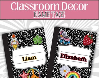 May include: Two black and white notebook-style name tags with colourful retro-themed stickers. The name tag on the left has a rocket, a four-leaf clover, a star, and a peace sign. The name tag on the right has roller skates, a strawberry, a daisy, and a rainbow. The name tag on the left says "Liam" and the name tag on the right says "Elizabeth".