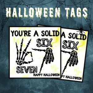 May include: Halloween tags with a spooky theme. The tags feature skeleton hands forming numbers and the phrases "YOU'RE A SOLID SIX" and "HAPPY HALLOWEEN". The background is a dark teal with spiderwebs.