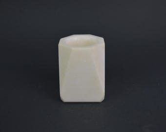 May include: A white ceramic hexagonal planter with a smooth, matte finish. The planter has a wide opening and a slightly rounded bottom.