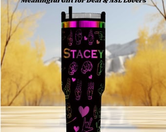 May include: A black tumbler with a custom name and ASL hand signs in neon colors. The tumbler has a black lid and a silver rim. The text on the tumbler reads "CUSTOM ASL NAME" and "Meaningful Gift for Deaf & ASL Lovers".