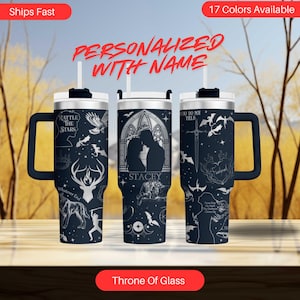 May include: A stainless steel tumbler with a black and silver design featuring a silhouette of a couple, a sword, and a dragon. The tumbler has a handle and a straw. The text "Rattle the Stars", "Whatever End", "You Do Not Yield", and "Stacey" is printed on the tumbler. The tumbler is a personalized gift for fans of the Throne of Glass series.