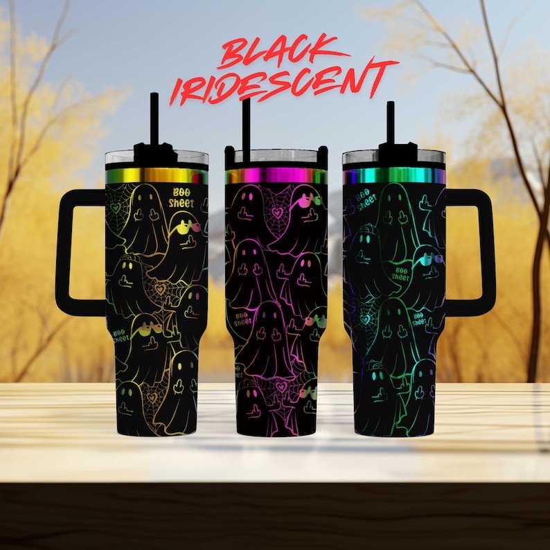 three colorful tumblers with a ghost pattern design, set against a blurred background of trees.