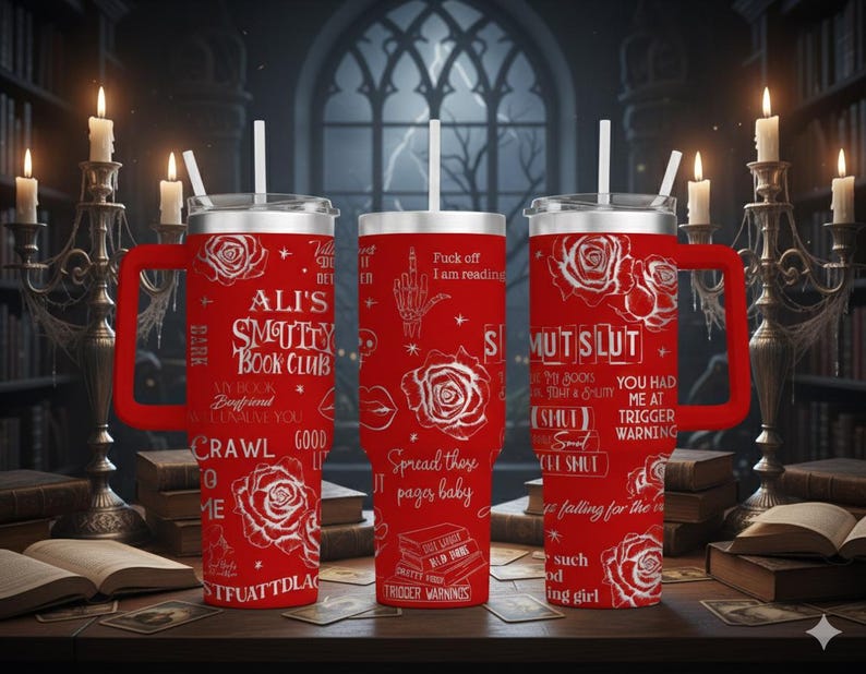 May include: Red insulated tumbler with a handle, featuring white text and rose graphics. The tumbler has the text "ALI'S SMUTTY BOOK CLUB" and other phrases. Includes a white straw and a silver lid.