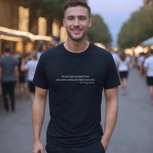 May include: A black t-shirt with a white quote from St. Augustine: "Thou hast made us for thyself, O Lord, and our heart is restless until it finds its rest in thee."