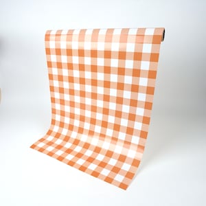 May include: A roll of orange and white gingham patterned wrapping paper.