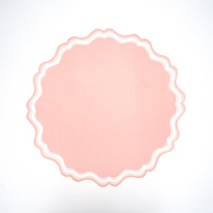 May include: A pink circle with a white scalloped border. The circle is a blank template for adding text or images.