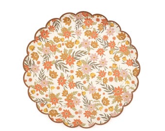 May include: A round scalloped edge paper plate featuring a repeating floral pattern with orange, yellow, and light pink flowers interspersed with green leaves on a cream background. The plate has a thin brown border along the scalloped edge.