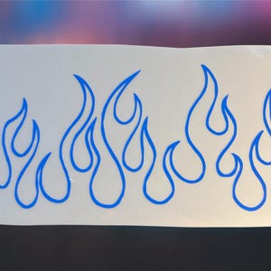 May include: A white sticker featuring a blue flame design. The flames are stylized with curved lines, creating a dynamic and energetic visual. The sticker is suitable for various applications, such as car decals or decorative accents.