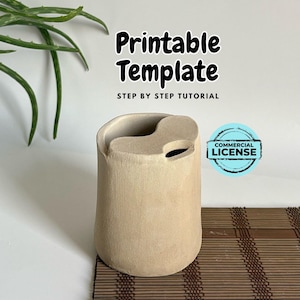 May include: A beige ceramic planter with a unique, asymmetrical opening. The planter is sitting on a brown bamboo mat. The image includes the text "Printable Template" and "Step by Step Tutorial".