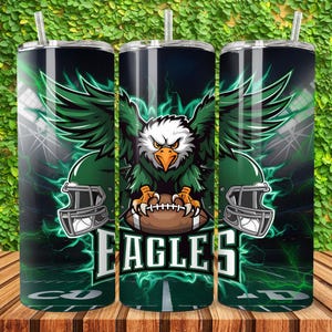 May include: A green and black tumbler with a graphic of an eagle holding a football. The tumbler has the word "EAGLES" written on it.