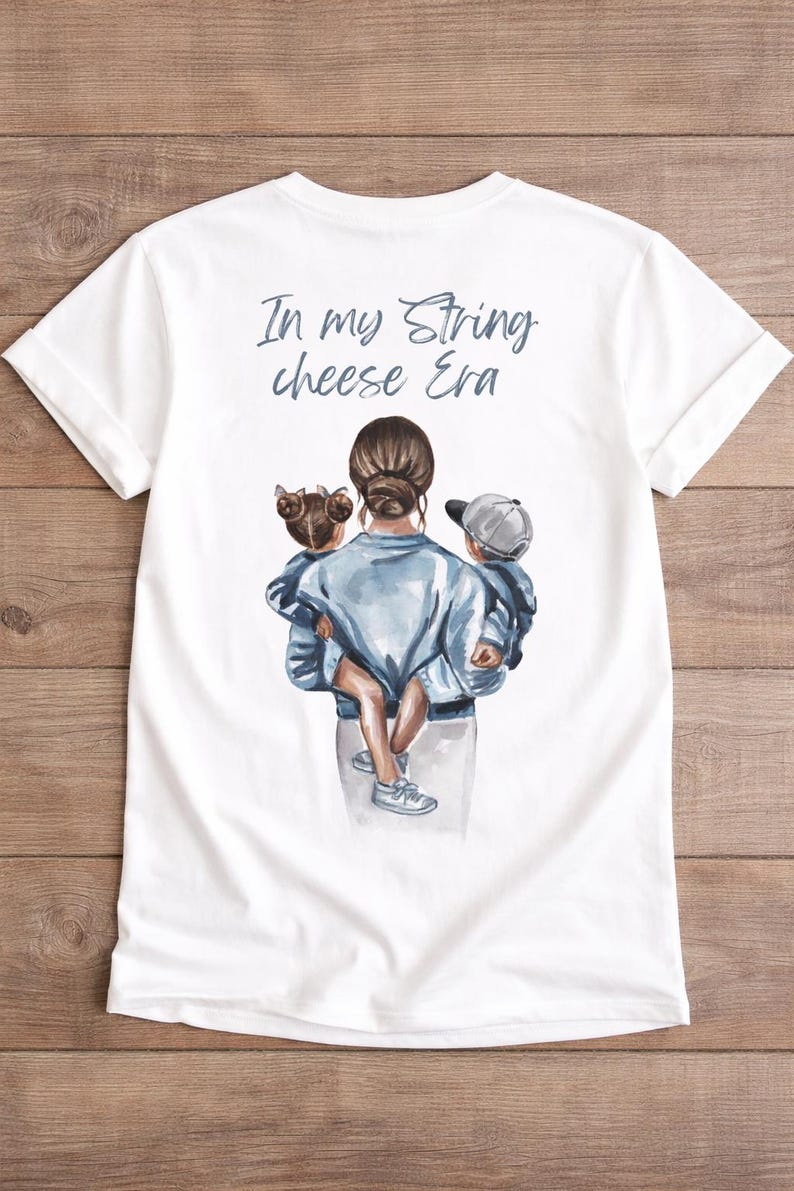 May include: White t-shirt with a watercolor illustration of a person holding two children. The text "In my String cheese Era" is printed in light blue above the illustration. The shirt has short sleeves and a crew neck.