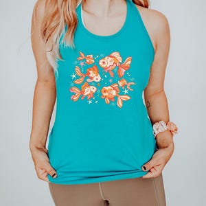 May include: A turquoise tank top with a colorful graphic of goldfish swimming in a circle. The goldfish are orange, yellow, and pink with black outlines.