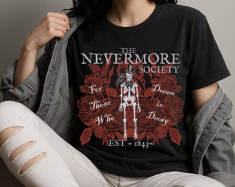 May include: Black t-shirt with a skeleton in a top hat and raven design, set against red roses. The text says "The Nevermore Society" and "For Those Who Dream in Decay, EST - 1843-".
