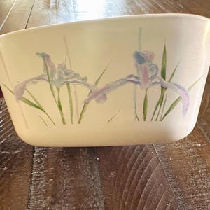 May include: A set of three ceramic mugs with a speckled, matte finish. The mugs are in shades of blue, green, and white. Each mug has a simple, modern design, perfect for coffee or tea. The mugs are likely handmade.