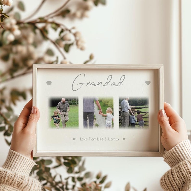 May include: A framed photo collage with the word "Grandad" in cursive script. The collage features three photos and the text "Love From Lillie & Liam xx". The frame is light-colored and rectangular, with small heart accents.