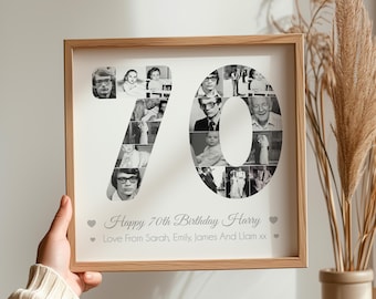 May include: A framed photo collage in a light wood frame. The collage is made up of black and white photos arranged in the shape of the number 70. The text "Happy 70th Birthday Harry Love From Sarah, Emily, James And Liam xx" is printed below the number.